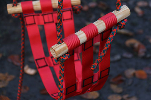 Stitch together a soft flexible swing for a child with flat webbing, tubular webbing, and dowels.